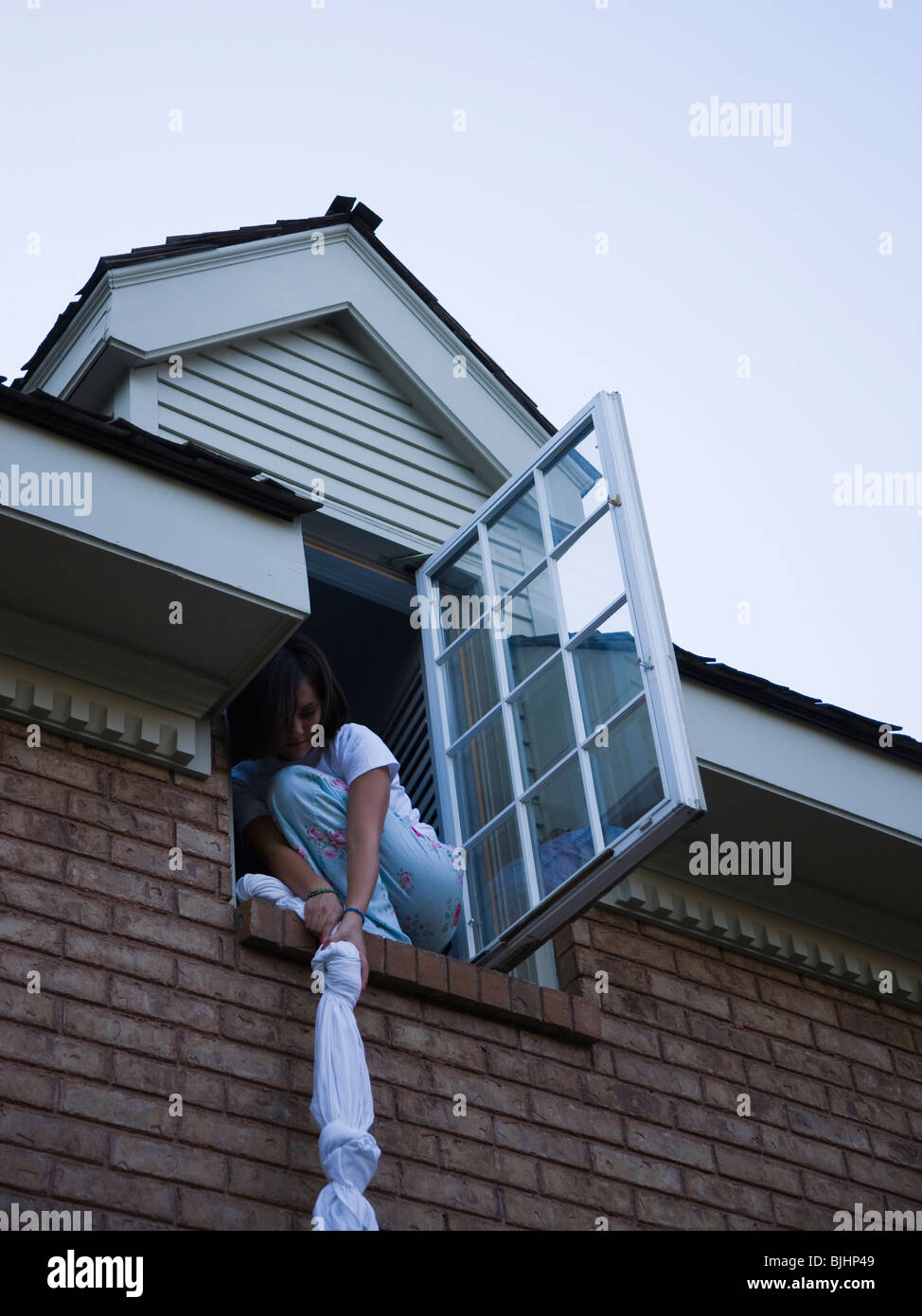 teenager climbing out of her bedroom window Stock Photo Alamy
