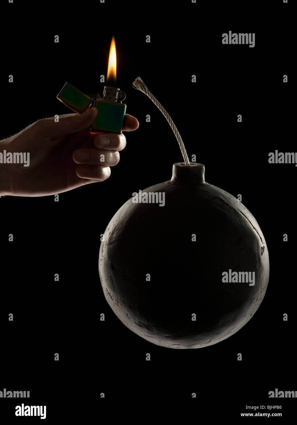 hand lighting the wick on a bomb Stock Photo Alamy