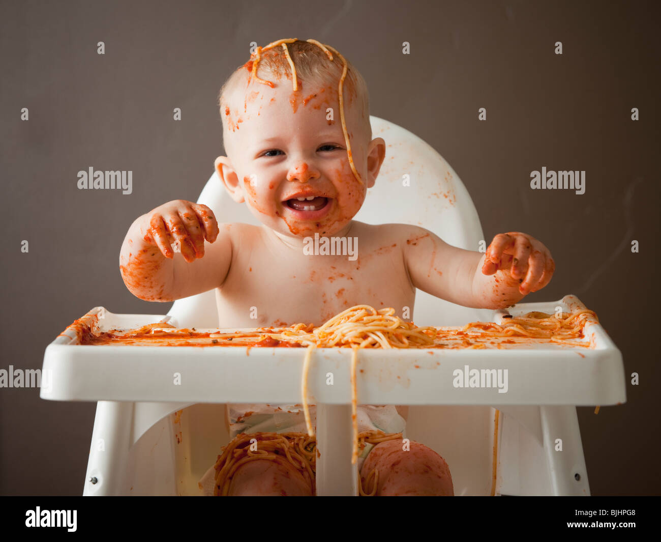 Baby covered in spaghetti Stock Photo Alamy