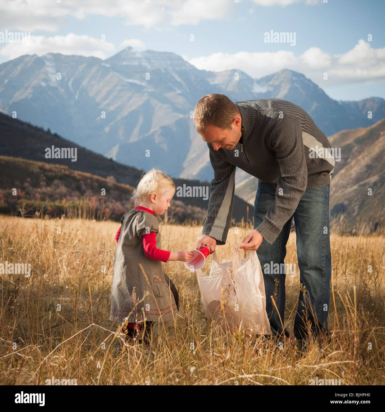 Father and child picking up litter Stock Photo Alamy