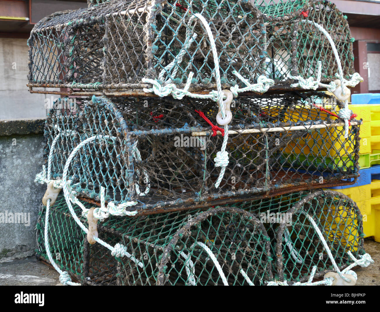 Crab and lobster pots stacked up on the harbour Stock Photo - Alamy