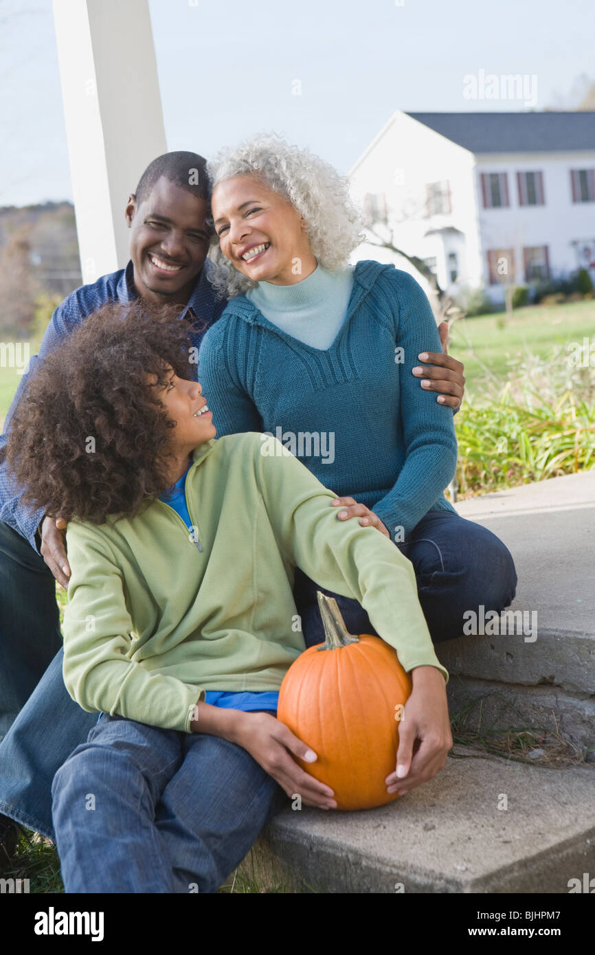 Family sitting on porch Stock Photo