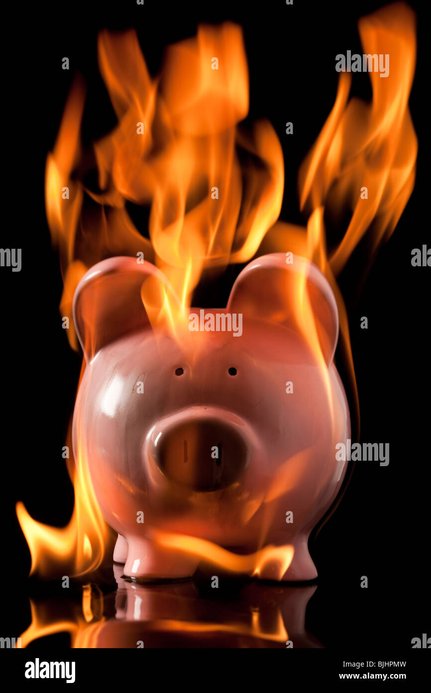 piggybank on fire Stock Photo