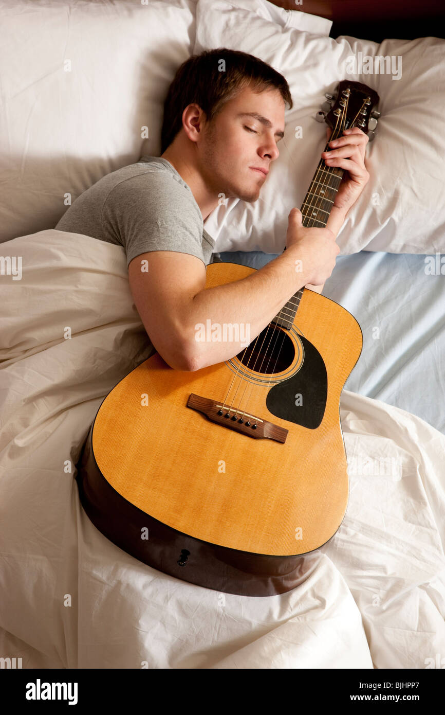 man sleeping with his guitar Stock Photo Alamy