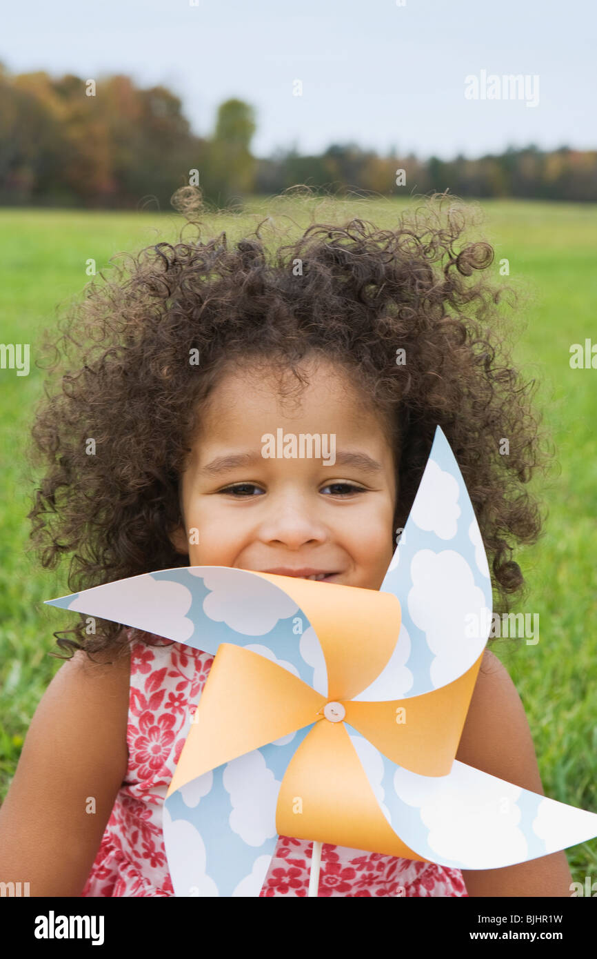 Young girl holding toy windmill Stock Photo