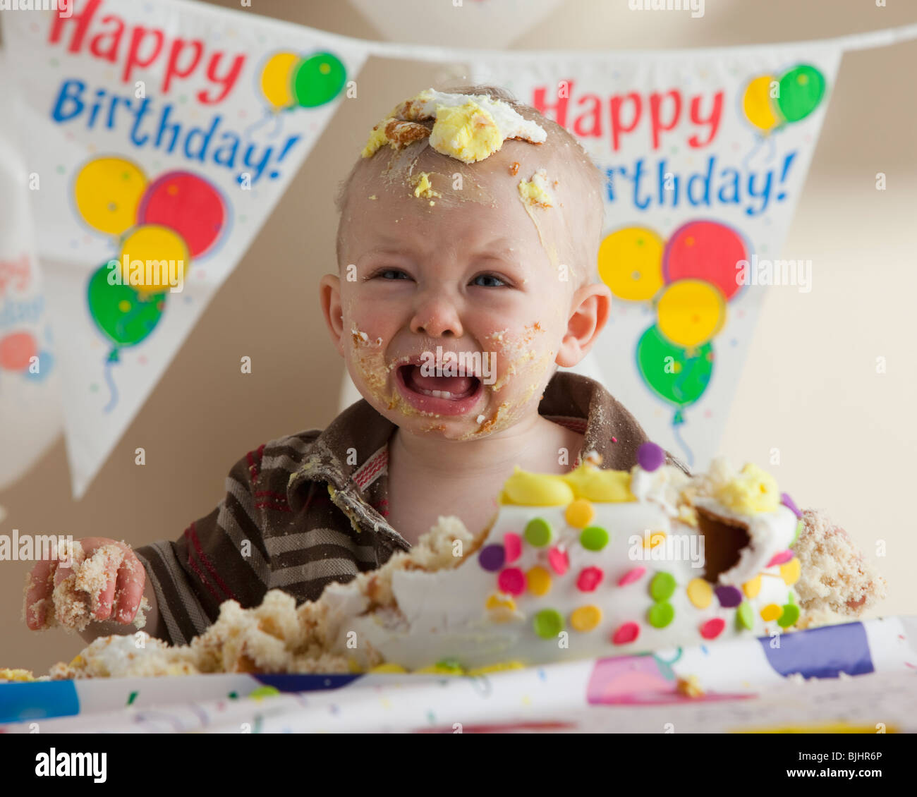 Baby covered in birthday cake Stock Photo Alamy