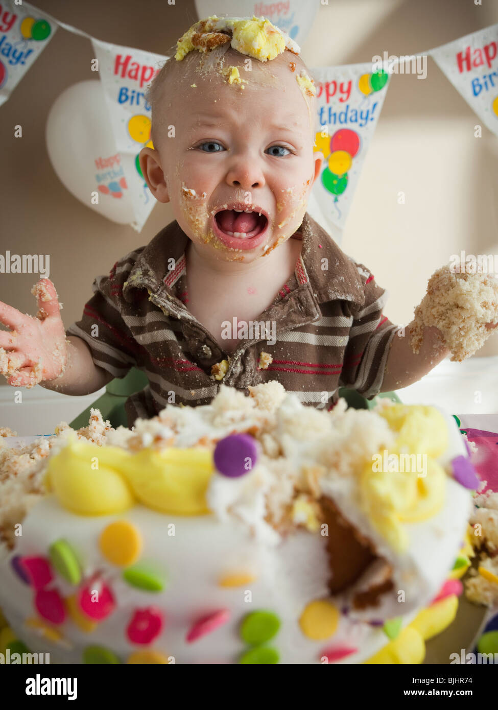 Baby covered in birthday cake Stock Photo Alamy