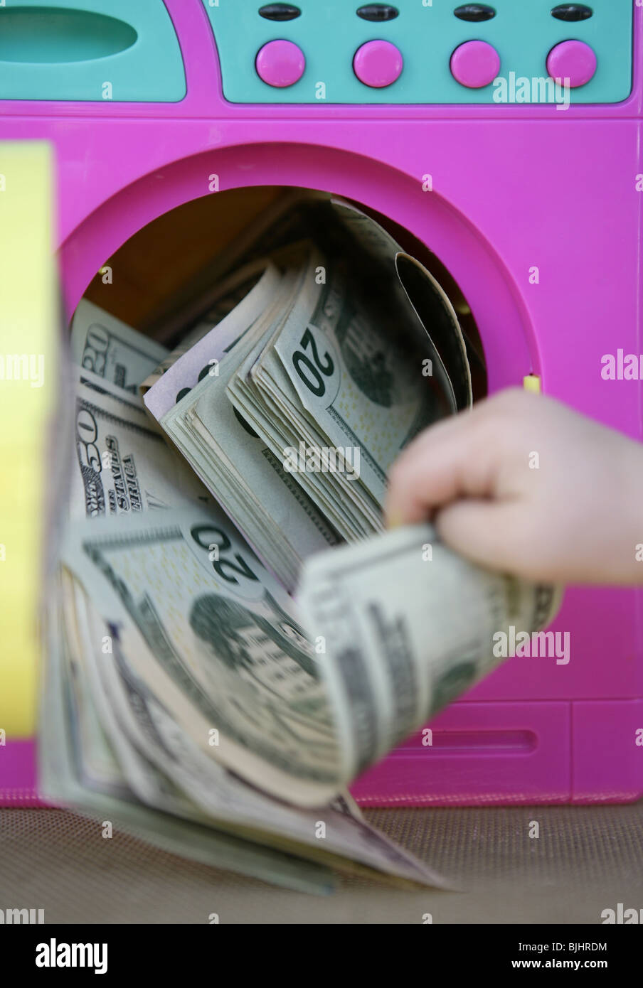 Cleaning black money dollar metaphor, laundry toy wahing machine Stock