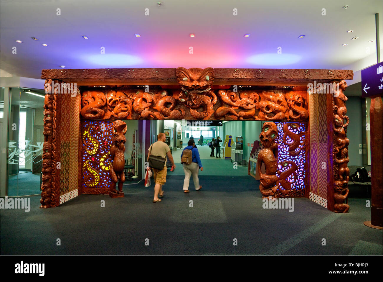 Auckland International Airport arrivals gate with Maori wooden carving