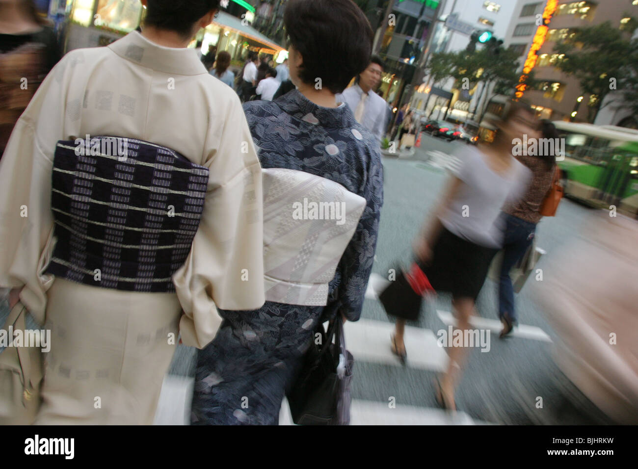 Japanese women in kimonos walking in Japanese city street. Stock Photo