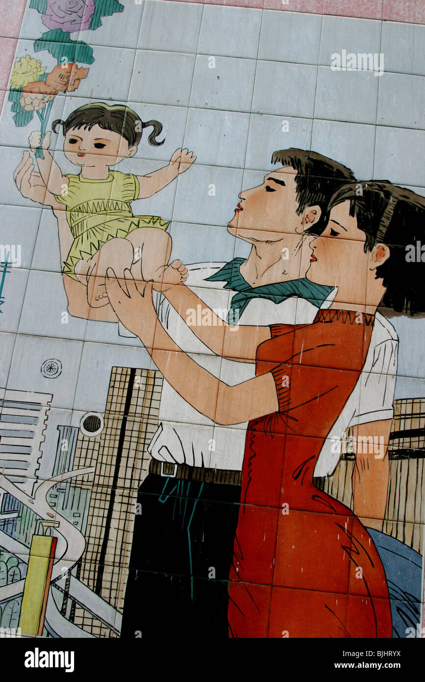 A tiled mural in a Guangzhou street advocates 'happy families', and China's 'one child' policy for families, China. Stock Photo