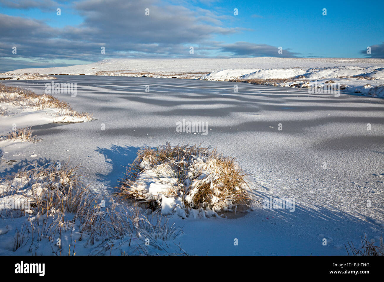Frozen pond Keepers Pond the Blorenge moorland in winter Wales UK Stock Photo