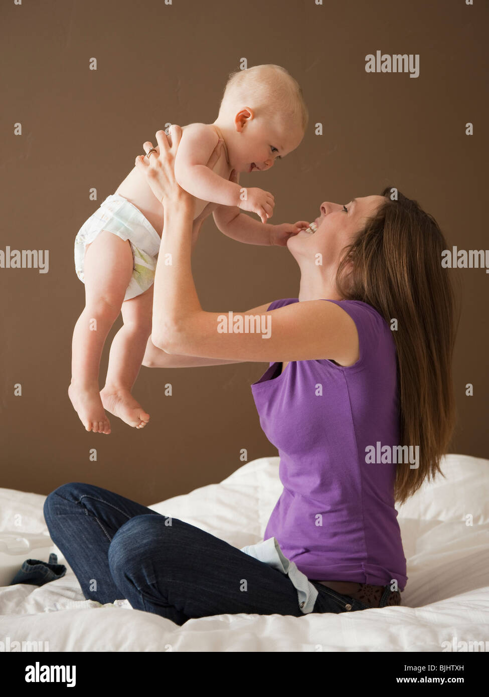 Woman holding baby Stock Photo - Alamy