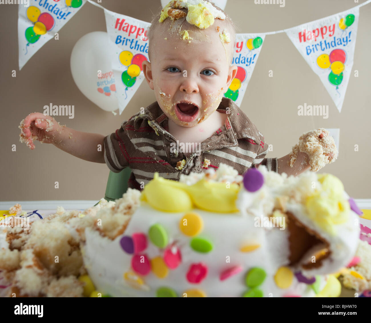 Baby covered in birthday cake Stock Photo Alamy