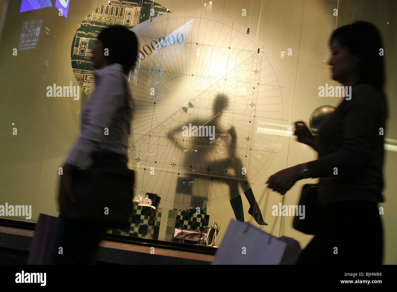 Women passing store window with mannequin, Tokyo, Japan. 22.09.05 Stock Photo