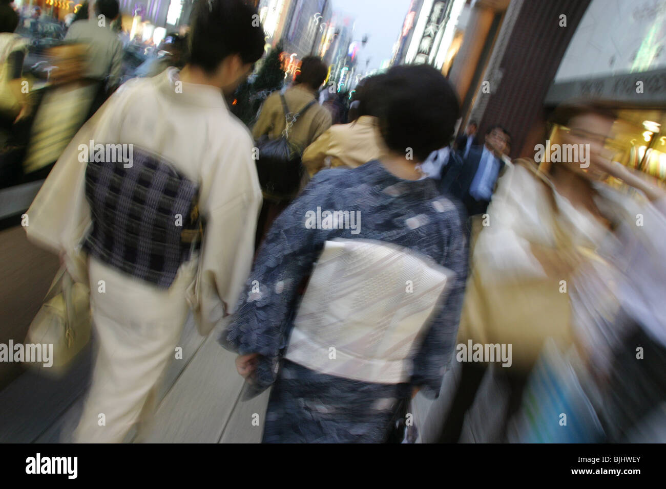 Japanese women in kimonos walking in Japanese city street. Stock Photo