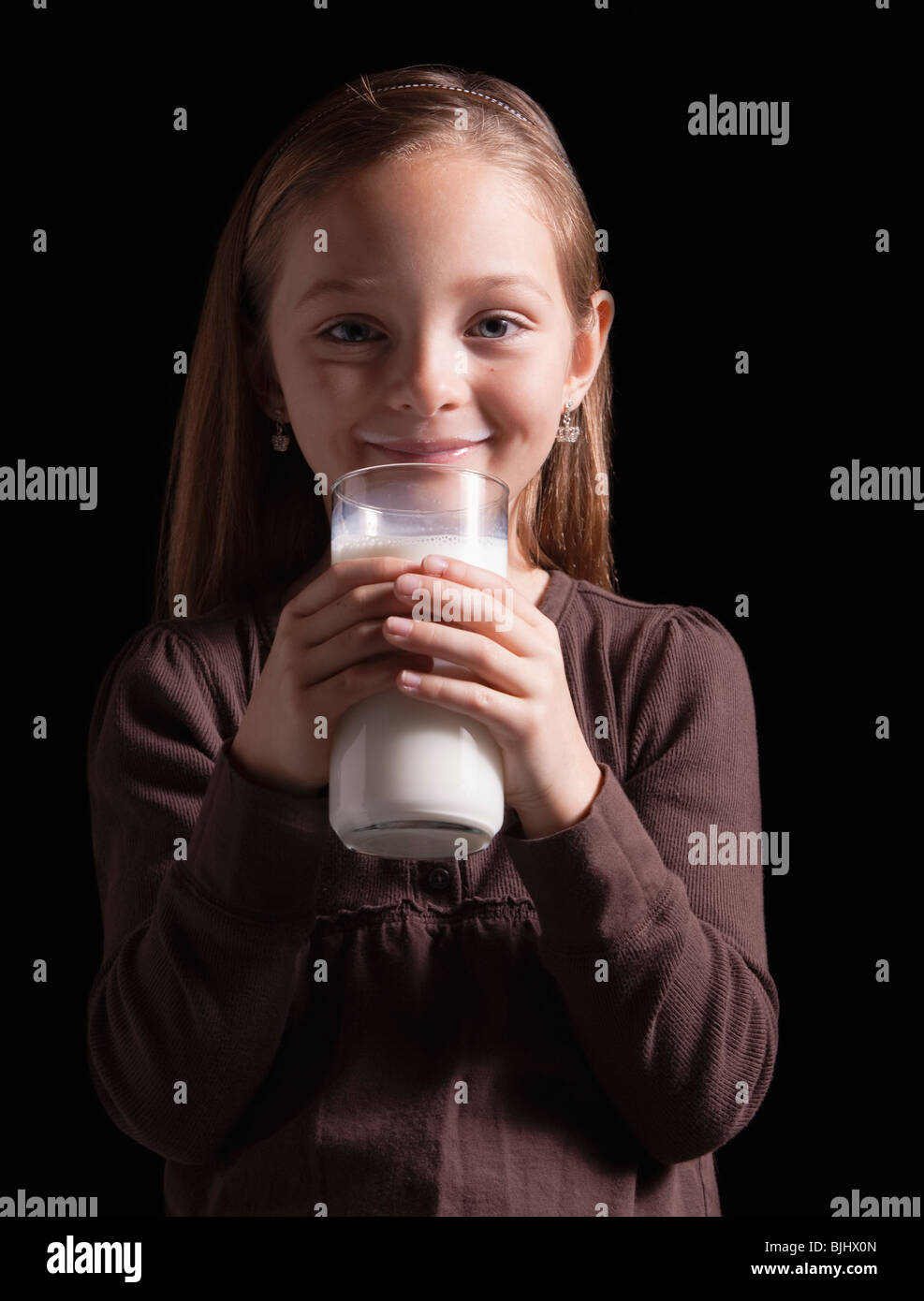 Young girl drinking glass of milk Stock Photo