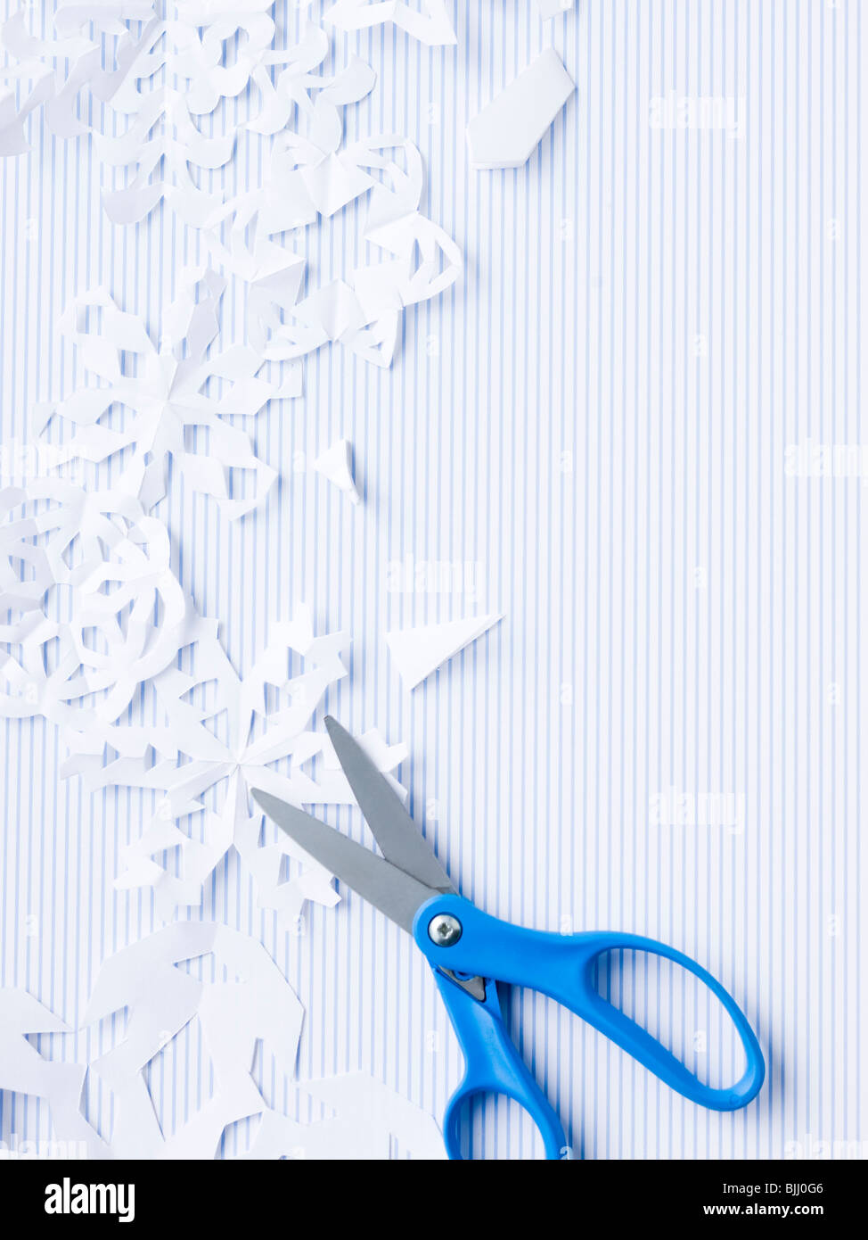 scissors and paper snowflakes Stock Photo