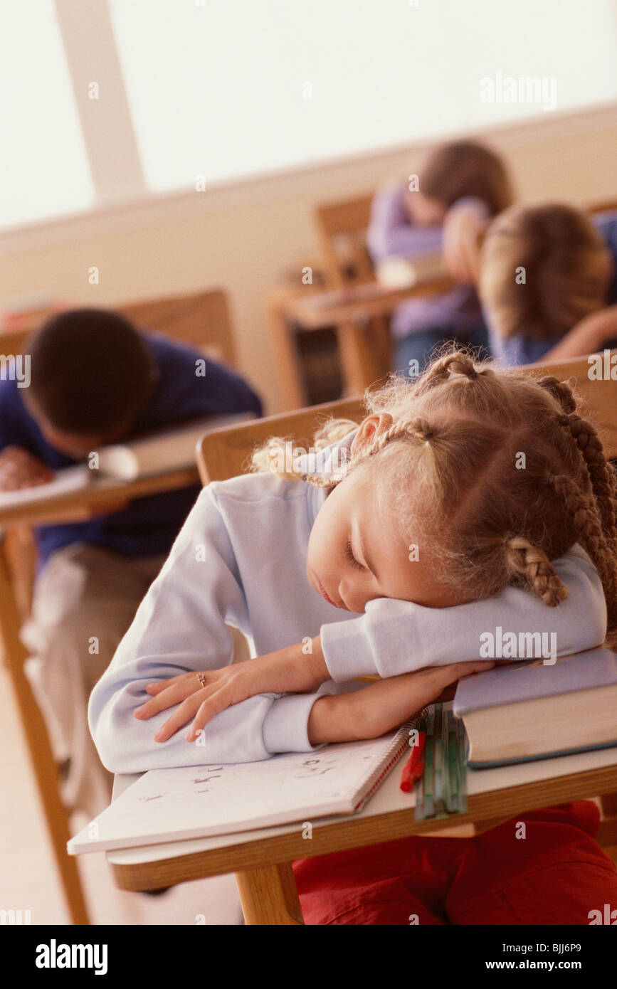 Students sleeping at desks Stock Photo