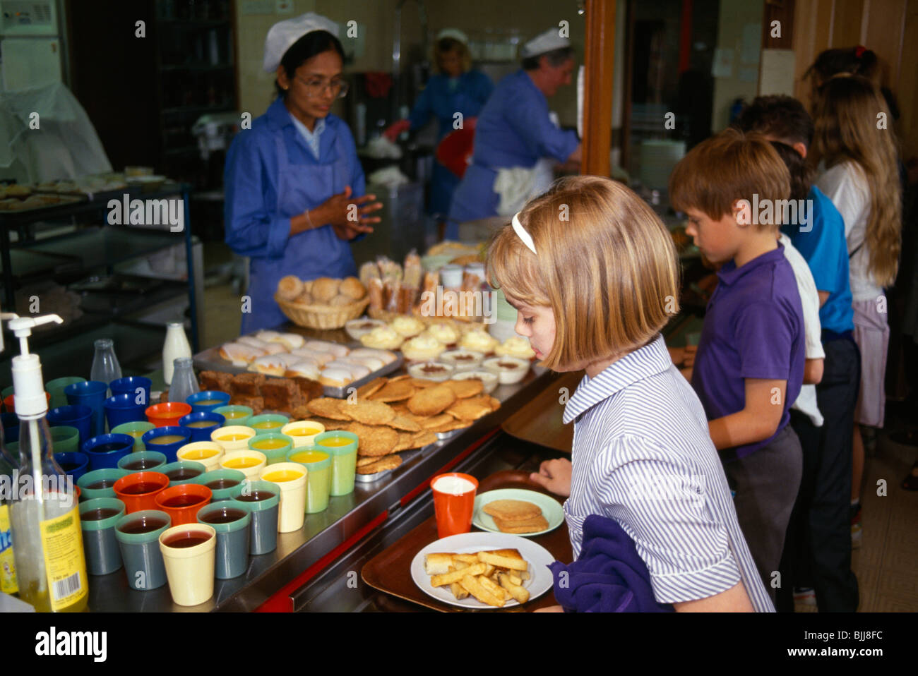 England, East Sussex, Brighton, Young girl collecting her hot meal from