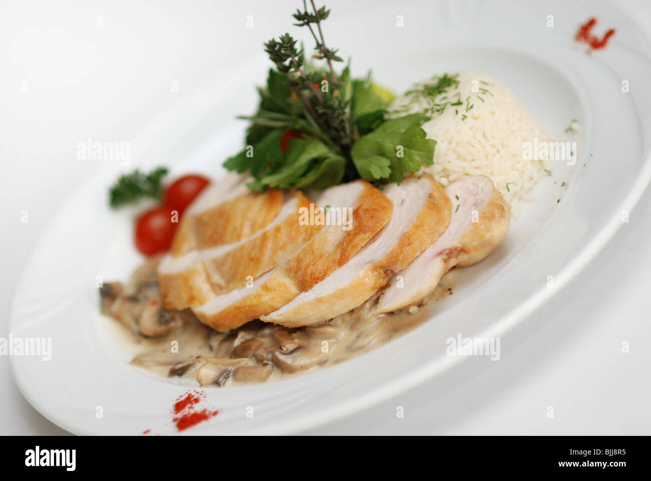 Chicken filled served with chanterelle sauce, rice and vegetables