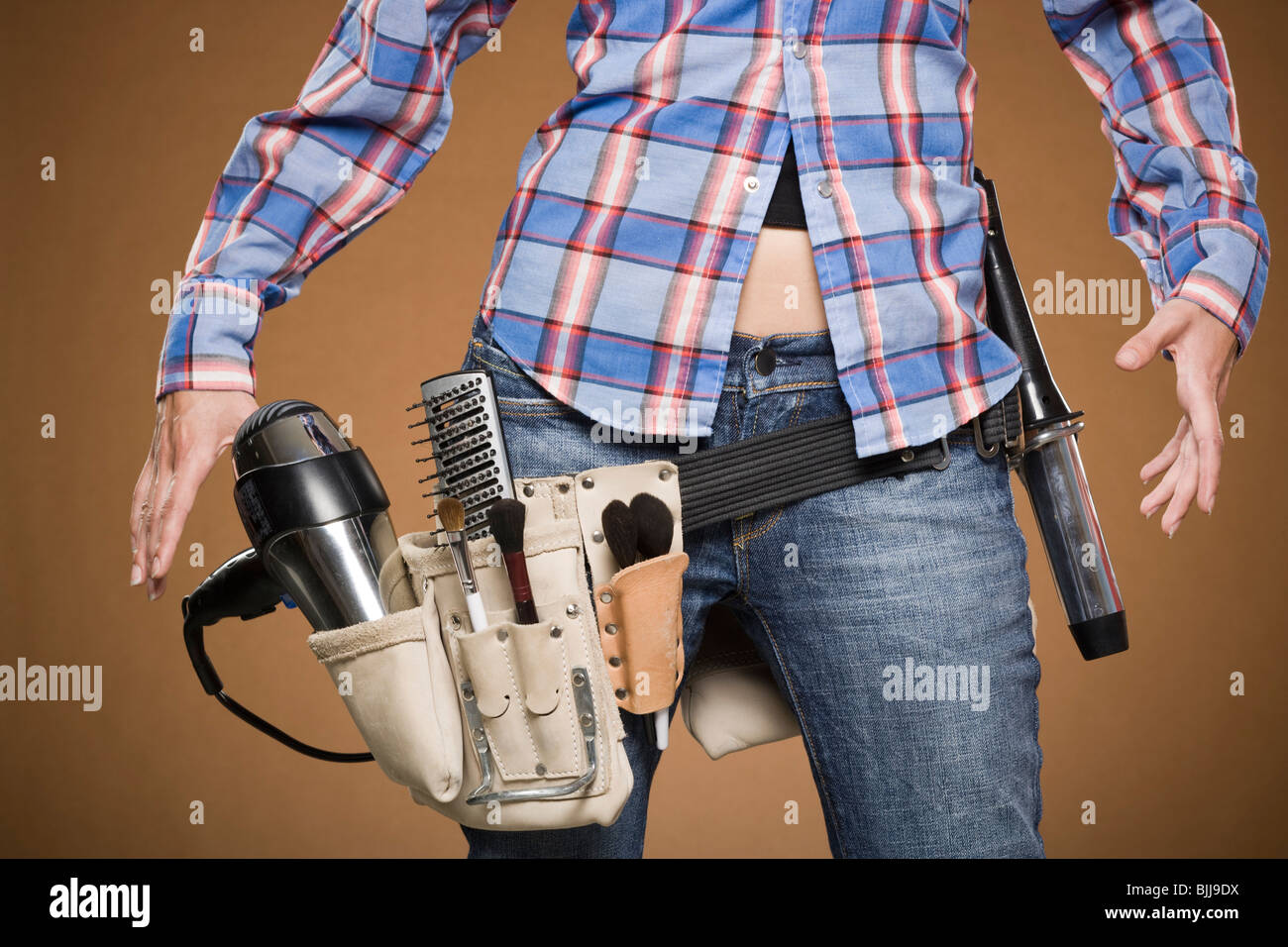 Mid section view of hairdresser with tool belt Stock Photo