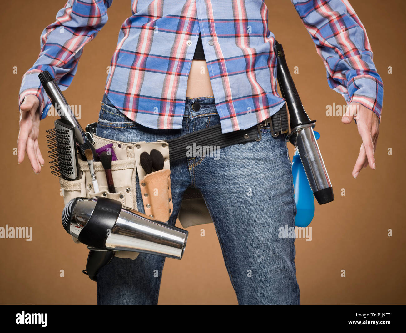 Mid section view of hairdresser with tool belt Stock Photo