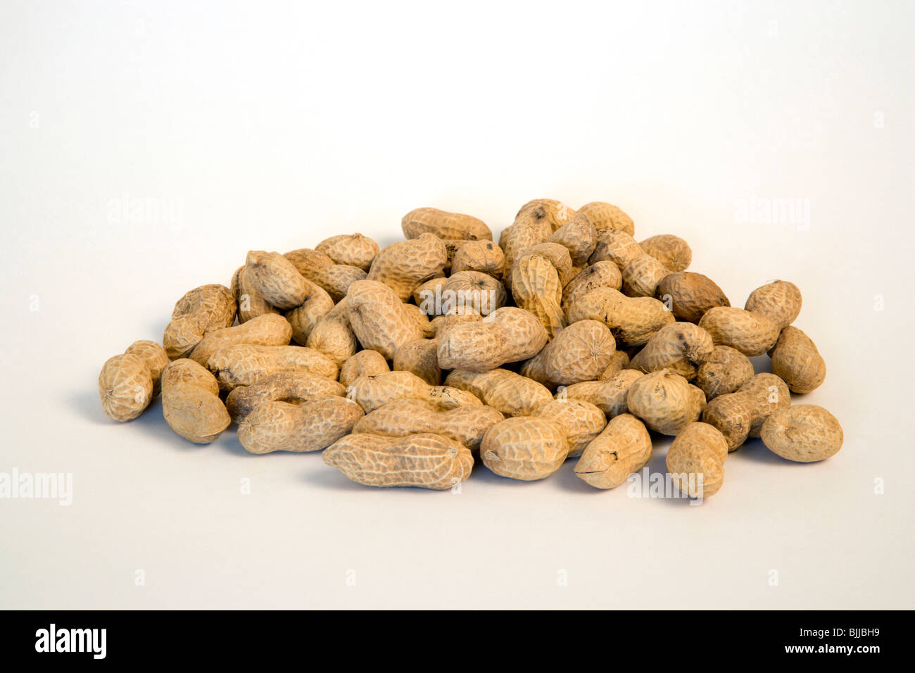USA, Food, Nuts, Groundnuts Peanuts in their kernels on a white background. Stock Photo
