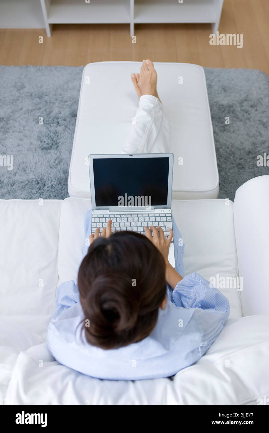 Young woman using laptop computer Stock Photo - Alamy