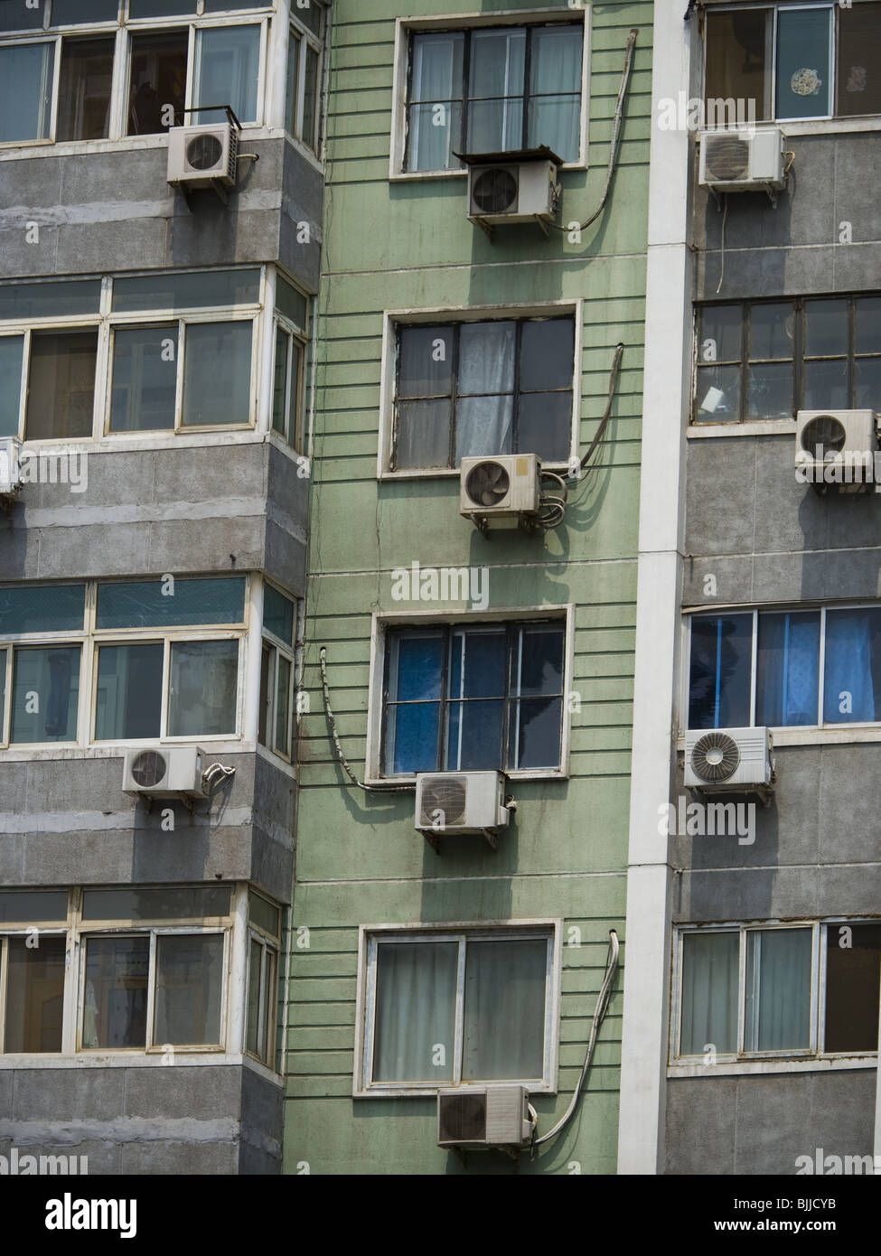 Detailed view of windows in apartment building with air conditioning
