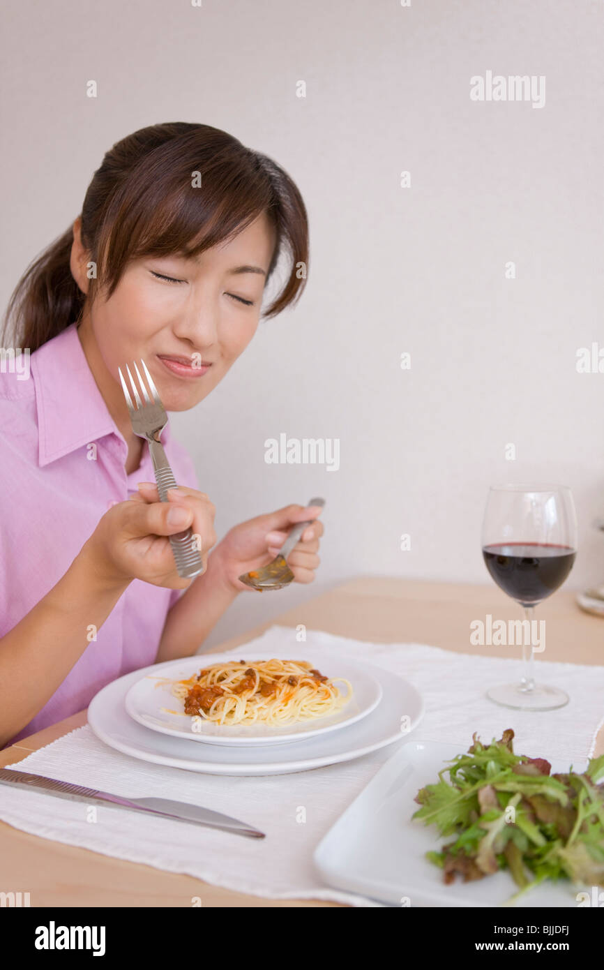 Young woman eating spaghetti Stock Photo