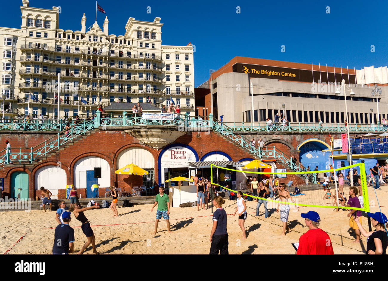 England, East Sussex, Brighton, Young people playing beach volleyball