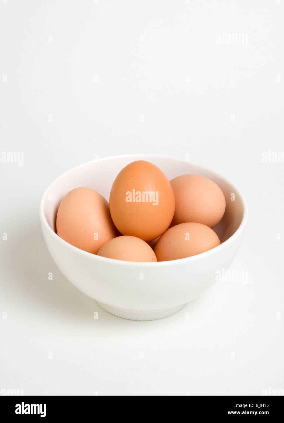 Food, Uncooked, Eggs, Free range eggs in a bowl on a white background. Stock Photo