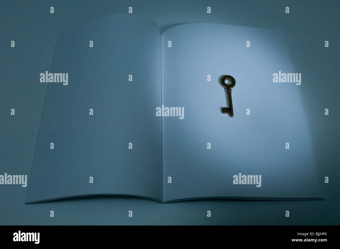 Antique key on a notebook Stock Photo - Alamy