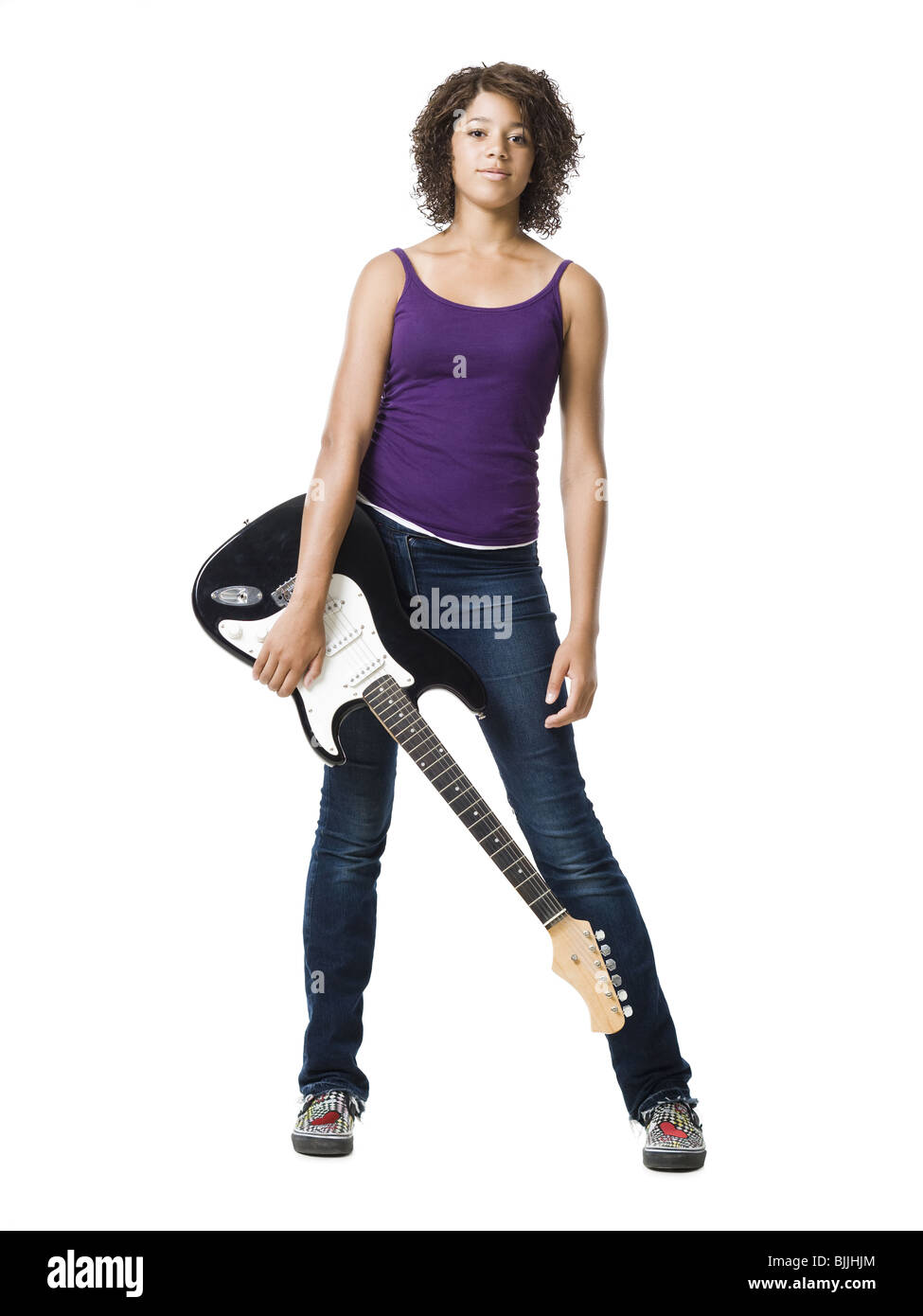 Girl standing and holding electric guitar Stock Photo - Alamy