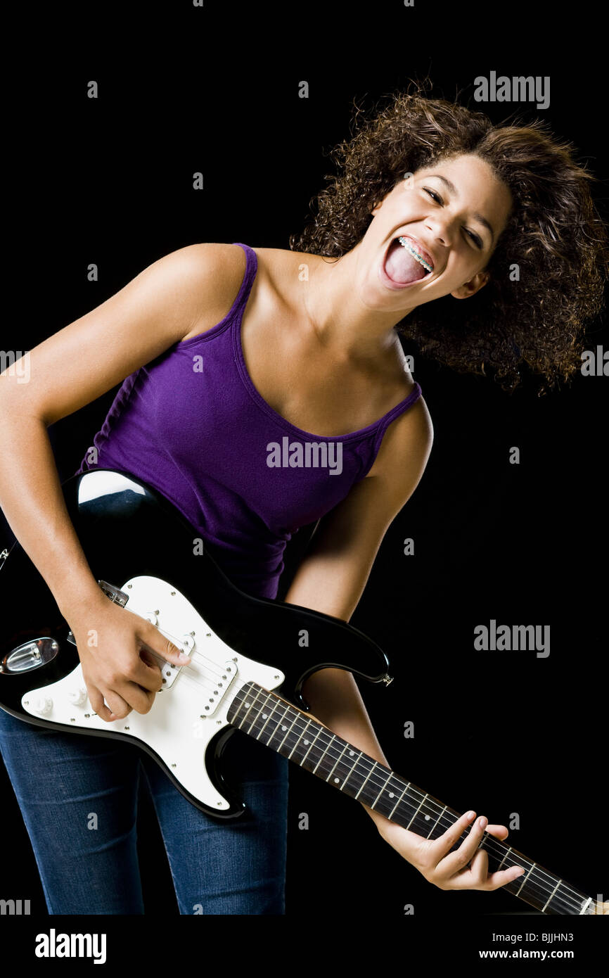 Girl playing electric guitar Stock Photo - Alamy