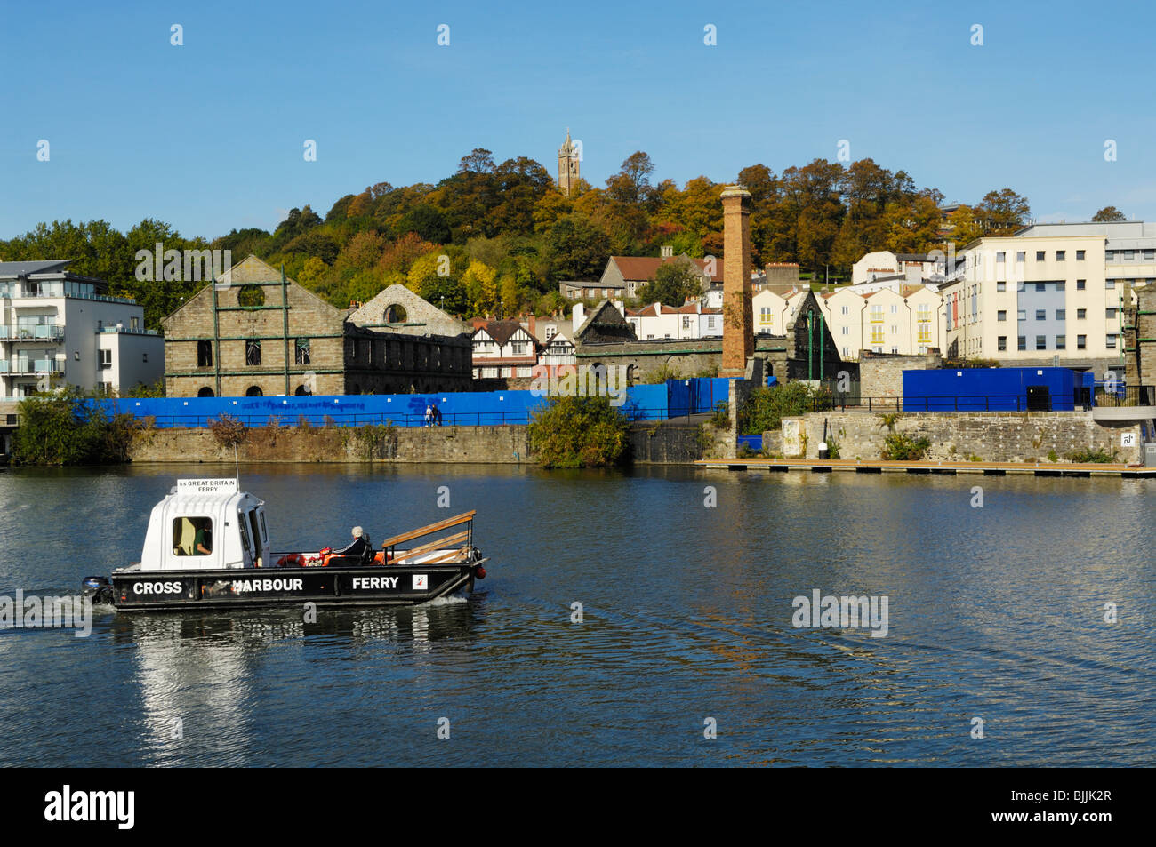 The Cross Harbour Ferry by Porto Quay in the Floating Harbour, Bristol, England. Cabot Tower is visible on Brandon Hill behind. Stock Photo