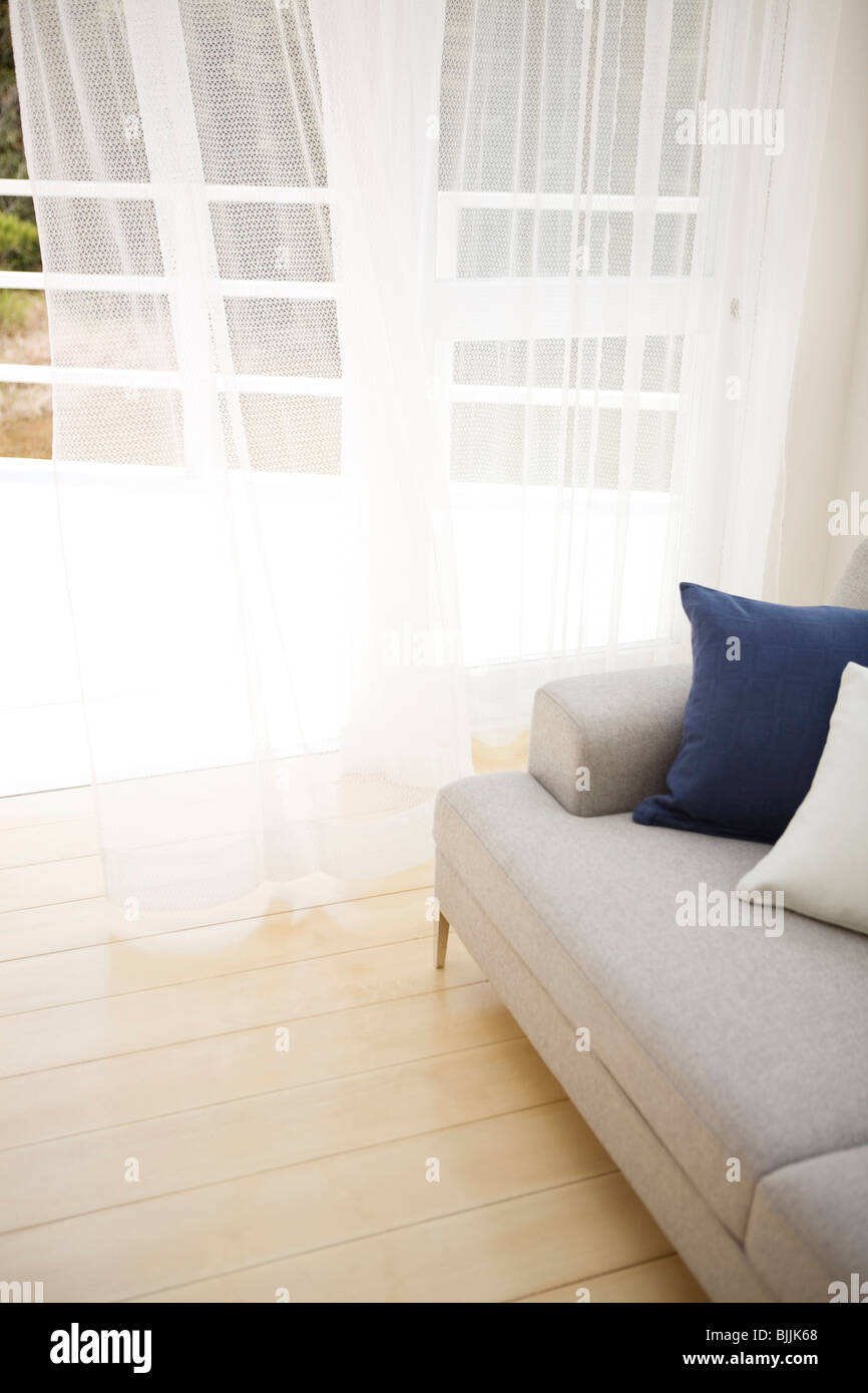 Couch in living room near open door Stock Photo Alamy