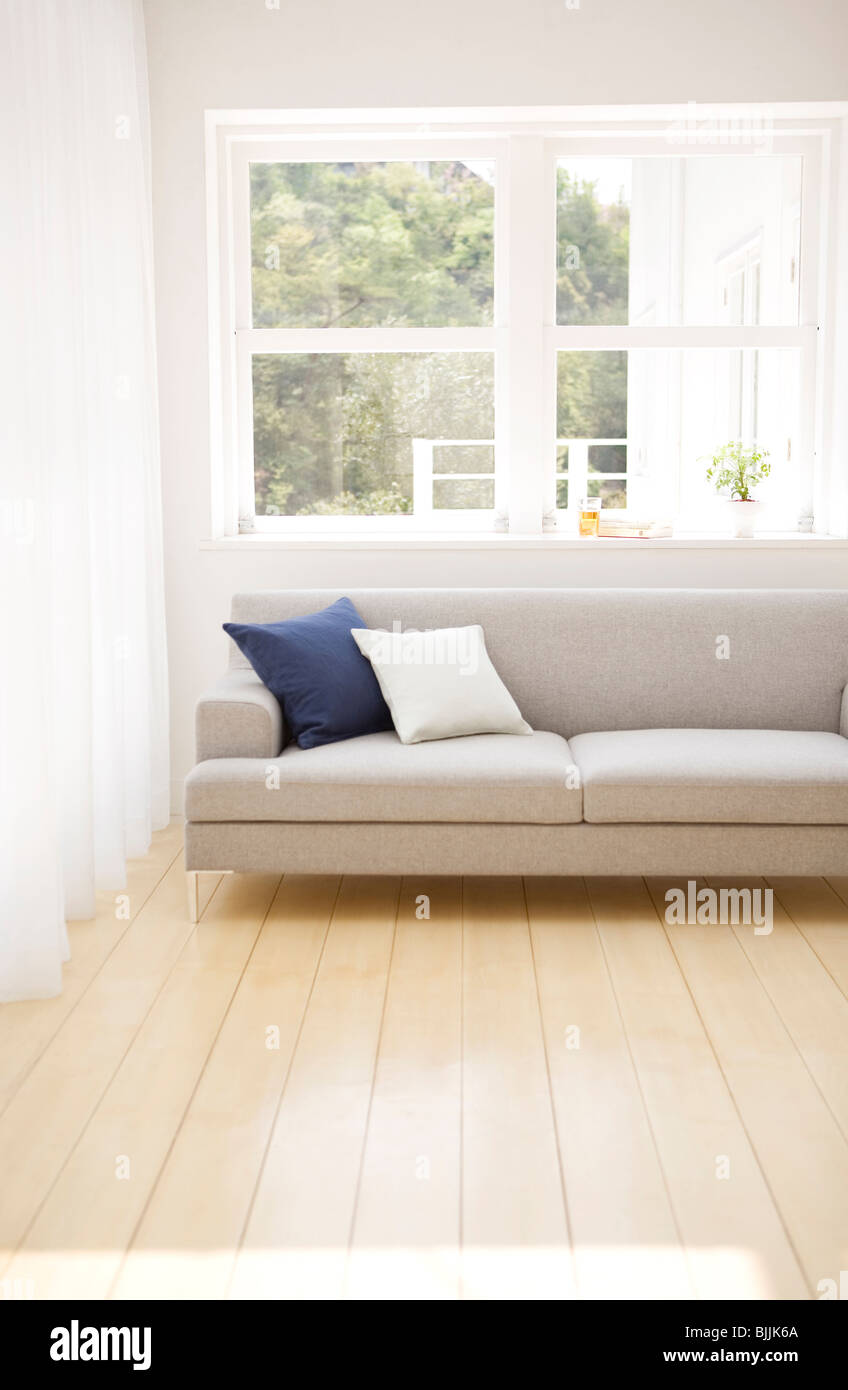 Sofa near window in living room Stock Photo Alamy