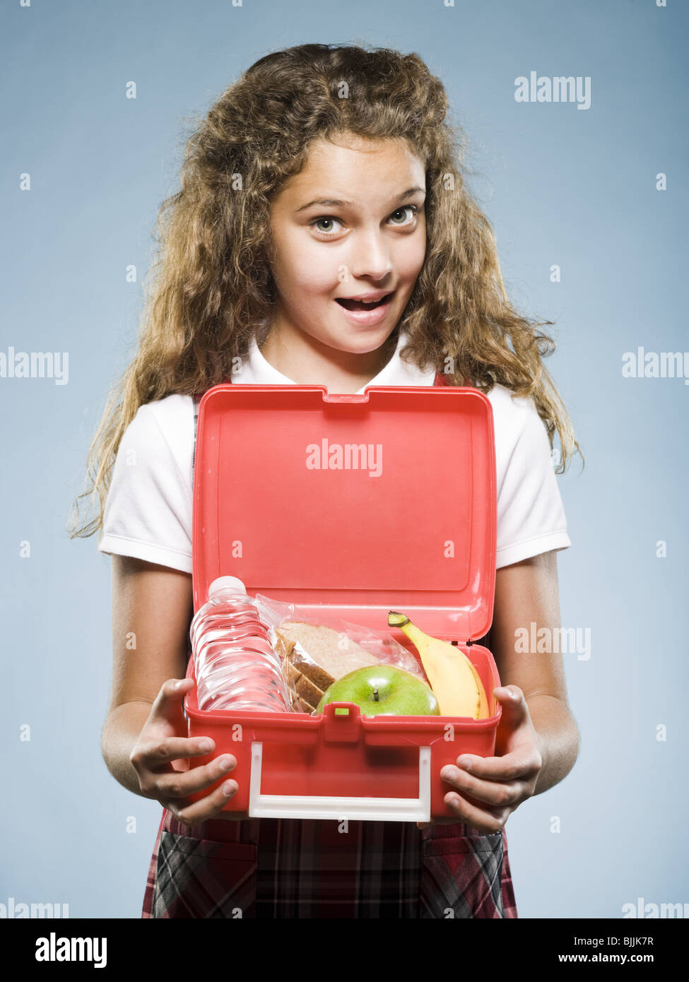 Girl holding lunch box with healthy food Stock Photo Alamy