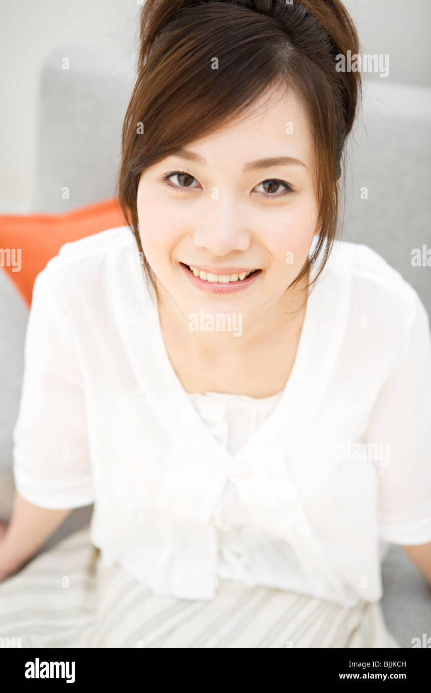 Woman happy sofa sitting hi-res stock photography and images - Alamy