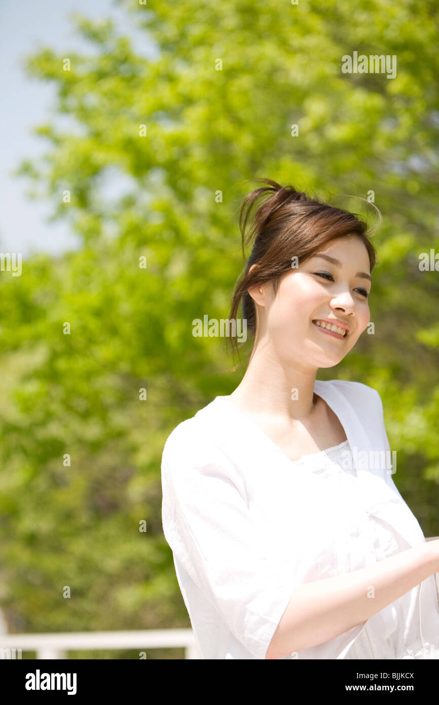 Woman leaning against a railing Stock Photo - Alamy