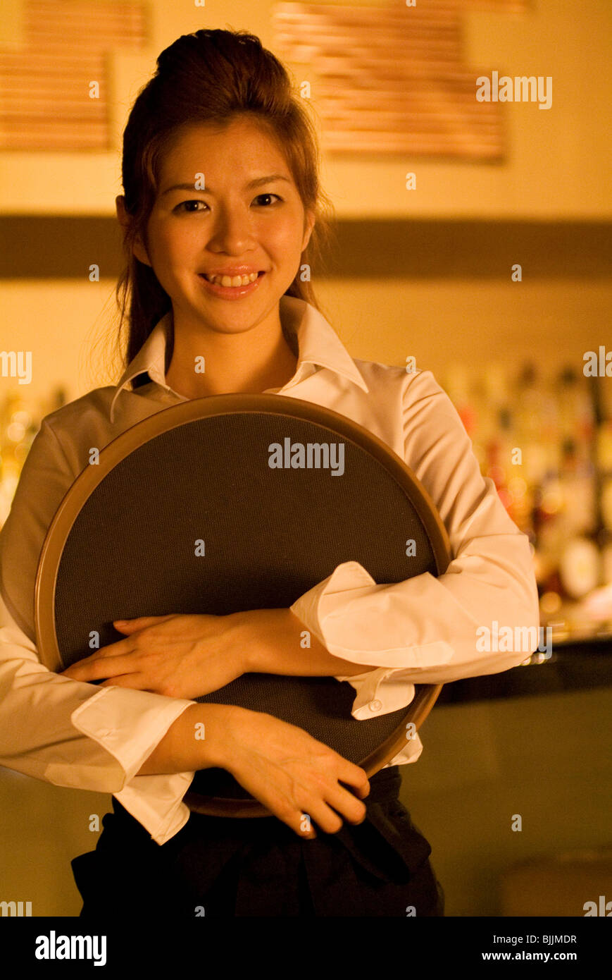 Waitress holding a tray Stock Photo Alamy