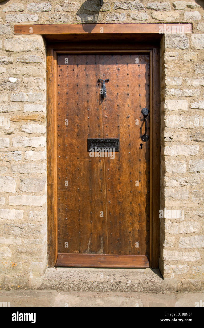 UK real estate. Traditional studded varnished wood front door Stock