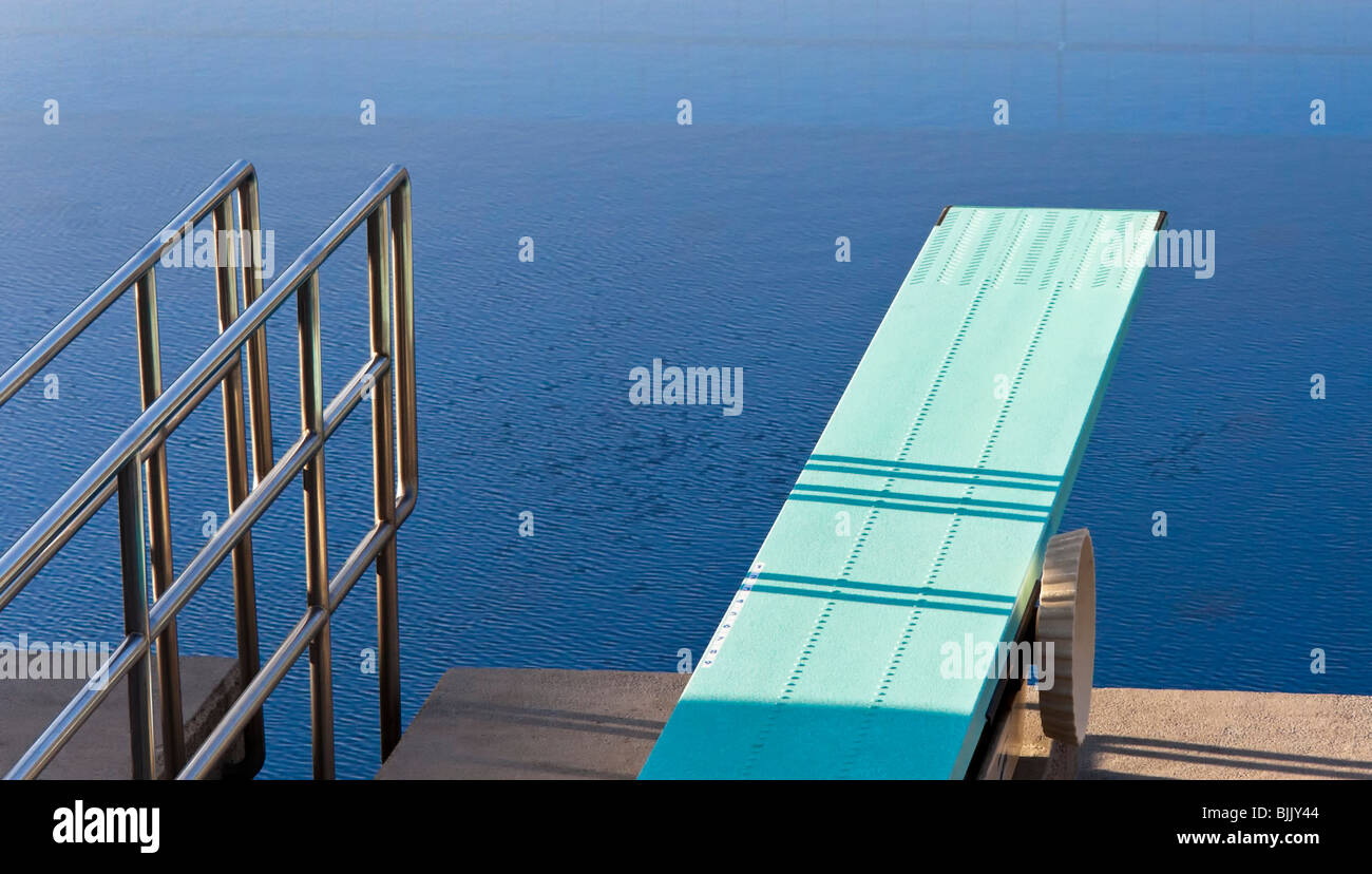 Diving board into a swimming pool Stock Photo