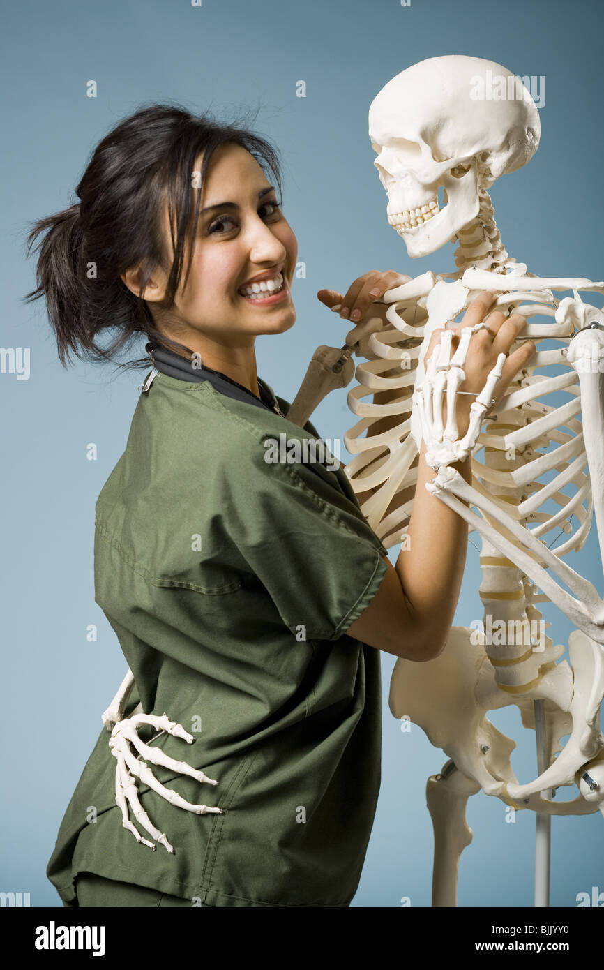 Woman in scrubs dancing with skeleton Stock Photo Alamy