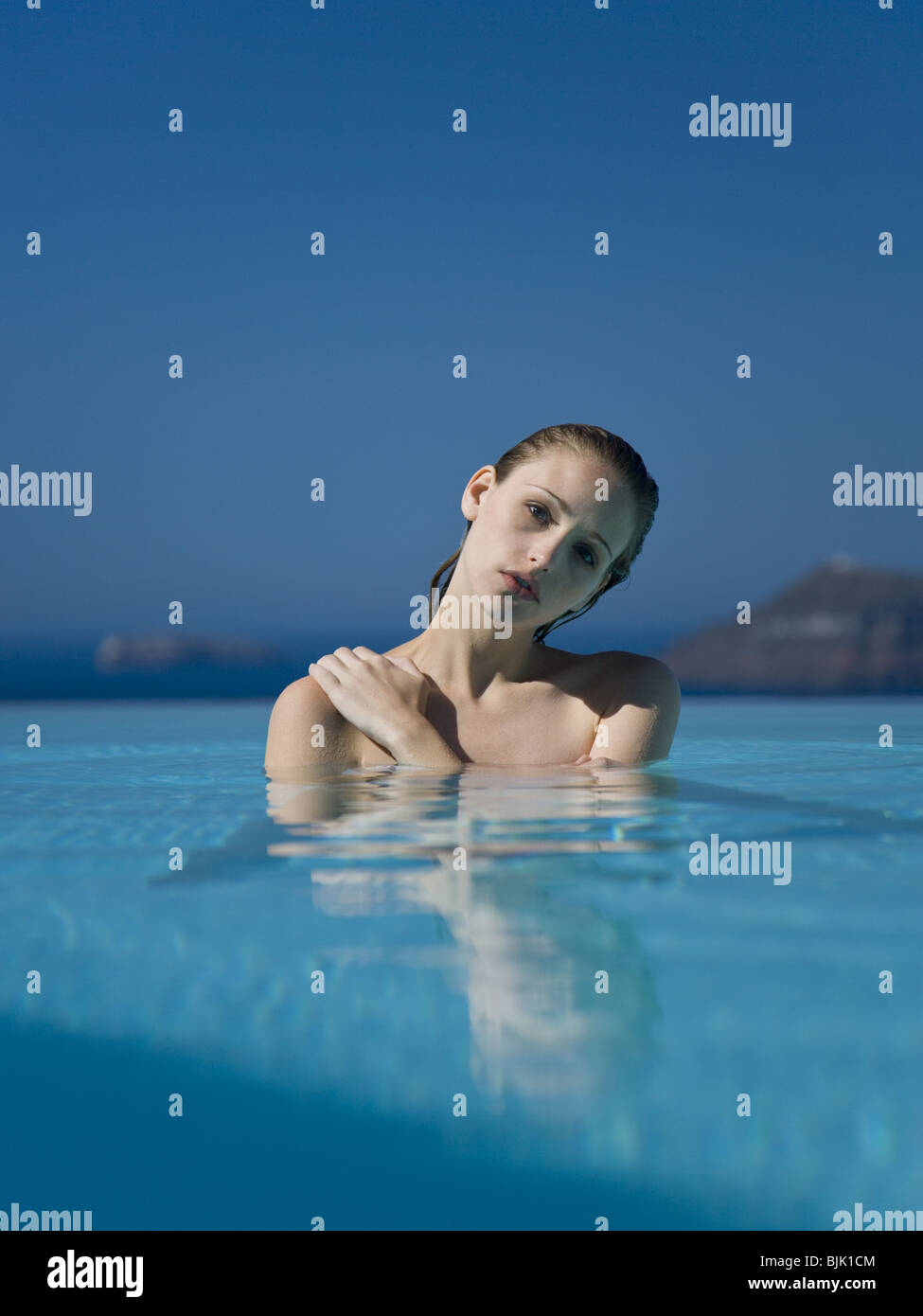 Woman in pool outdoors Stock Photo