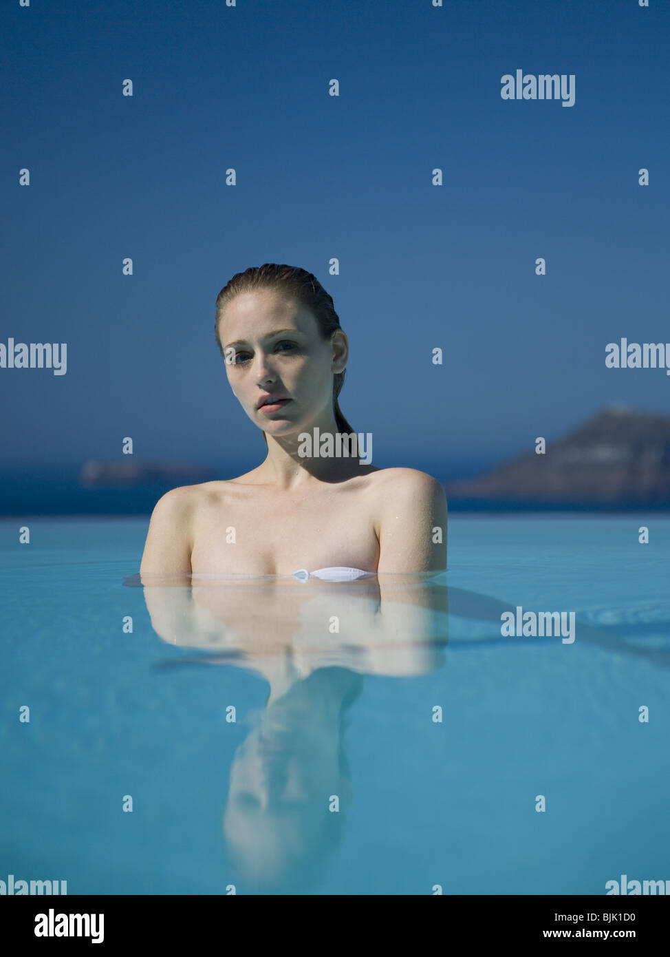Woman in pool outdoors Stock Photo