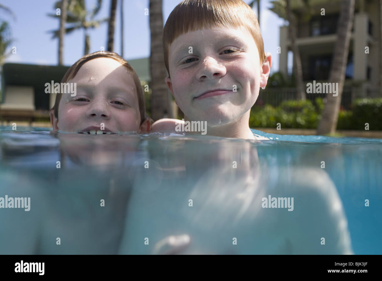 Two boys in outdoor pool smiling Stock Photo Alamy