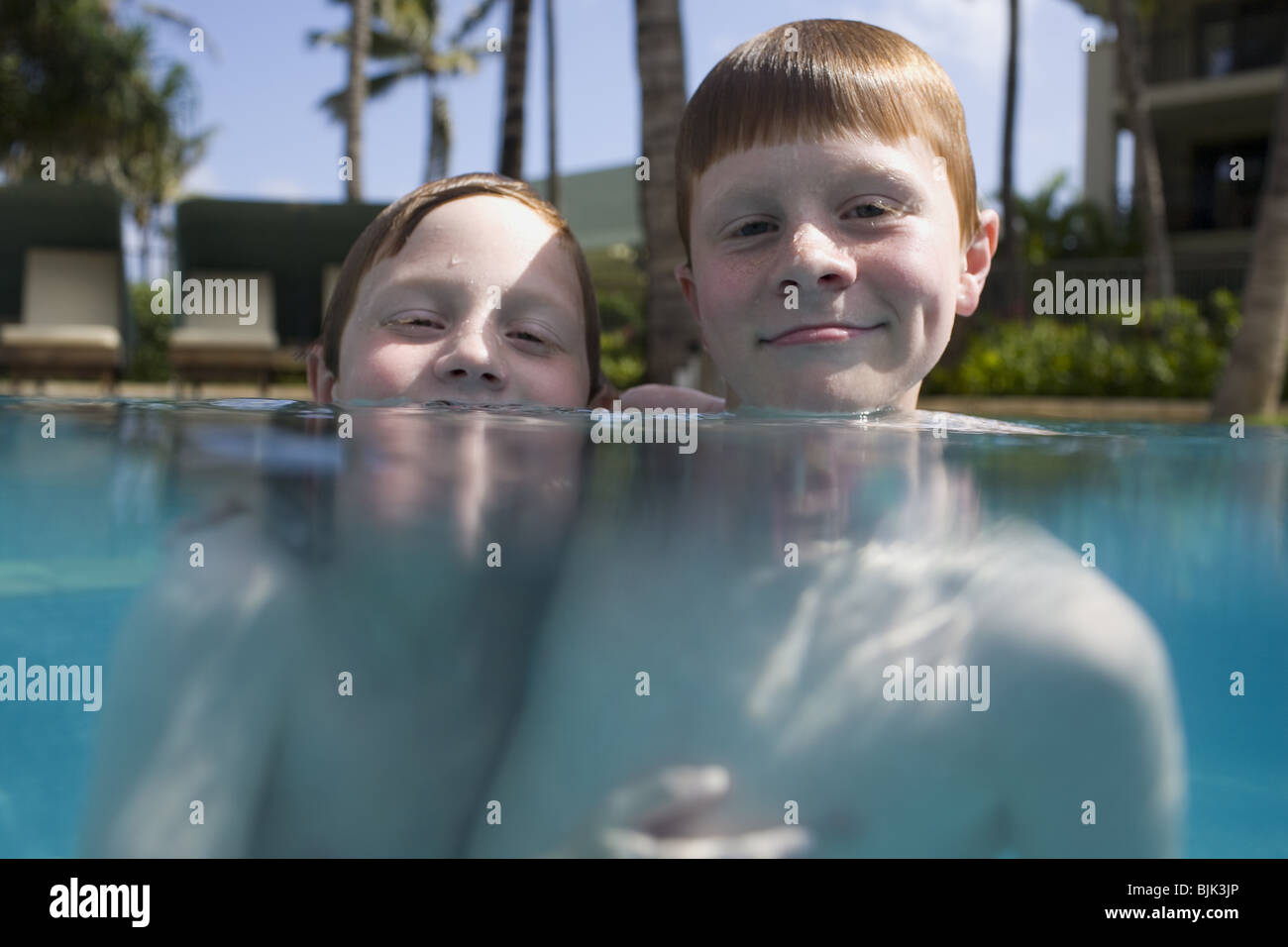 Two boys in outdoor pool smiling Stock Photo Alamy